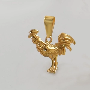 Close-up of a 18k gold plated stainless steel rooster pendant with polished metal finish