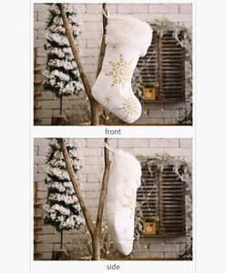 Detail of plush Christmas stocking featuring golden snowflake embroidery and sequins
