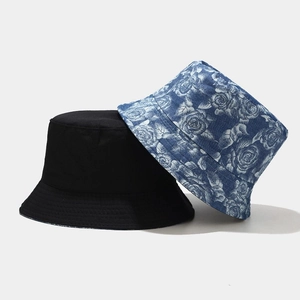 Detail of floral print and solid black reversible cotton bucket hat with canvas texture