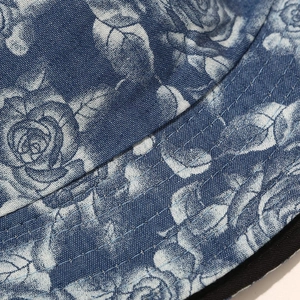 Detailed macro view of the blue floral print and reinforced stitching on the bucket hat brim