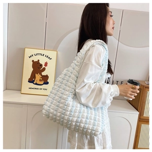 Close-up of blue and white checkered tote bag with textured puffy bubble fabric