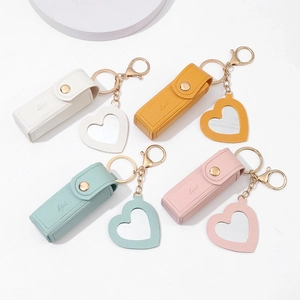 Detailed set of four lychee texture PU leather lipstick pouches with heart-shaped mirrors