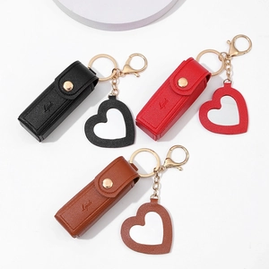 Three PU leather mini lipstick cases in black, red, and brown with heart-shaped mirrors