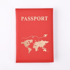 Close-up of red PU leather passport holder with gold world map and passport engraving