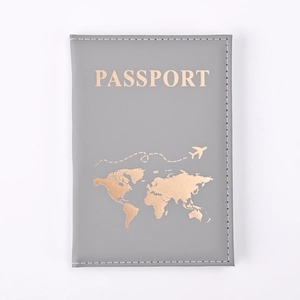 Detailed close-up of grey PU leather passport holder with golden world map stamping
