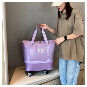 Close-up of a purple Oxford cloth travel bag featuring expansion layer and 360 wheels
