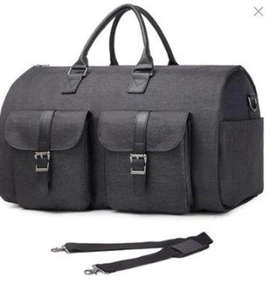 Close-up of durable dark grey travel garment bag with dual front pockets and shoulder strap