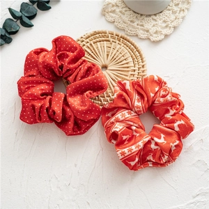 Christmas velvet hair scrunchies with white polka dots and reindeer patterns in red and orange