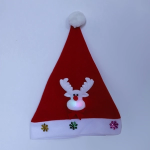 Close-up of glowing reindeer nose and glittery snowflakes on kids Christmas hat