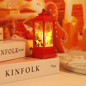 Detail of red Christmas lantern featuring Santa silhouette and warm LED festive light