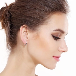 Minimalist S925 sterling silver hoop earrings worn by a model for a classic silver look
