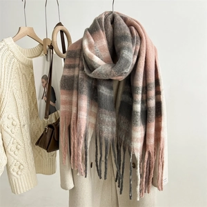 Close-up of pink and grey checkered mohair scarf with soft fringe details