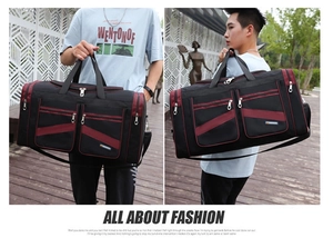 Detail of black and red oxford fabric travel bag featuring dual zippered front pockets