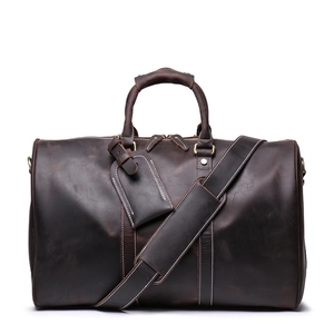 Deep brown crazy horse leather travel bag with sturdy handles and adjustable shoulder strap