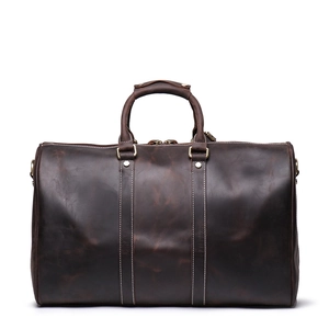 Detailed view of dark brown crazy horse leather travel bag with durable metal hardware