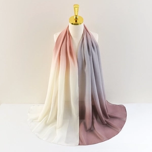 Detail of soft gradient chiffon shawl on mannequin showing cream to pink color transition