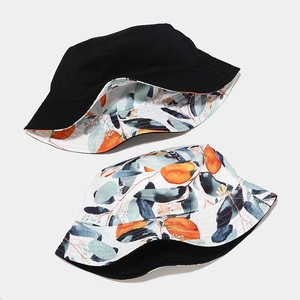 Reversible bucket hat with fruit print and solid black canvas for sun protection