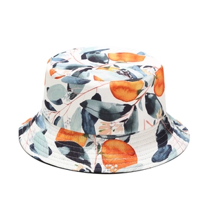 Reversible bucket hat with orange and leaf print on white background for sun protection