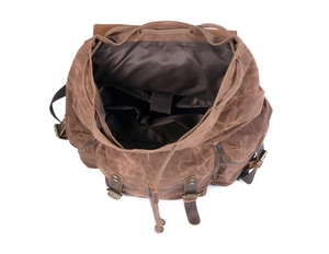 Internal view of vintage waxed canvas backpack showing spacious multi-pocket compartments