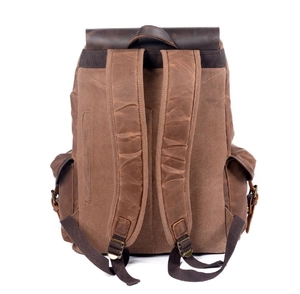 Detail view of the vintage oil wax canvas backpack showing padded straps and side pockets