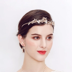 Detail of bridal headband and earring set with golden flowers and sparkling rhinestones
