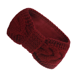 Detail of burgundy chunky knit headband with warm fleece lining and twisted design