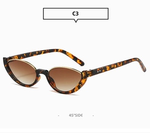 Dettaglio occhiali da sole ovali cat-eye con motivo tartarugato e bordo interno dorato