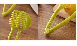 Detail of yellow-green plastic lemon slicer showing grid head and ergonomic handle grip