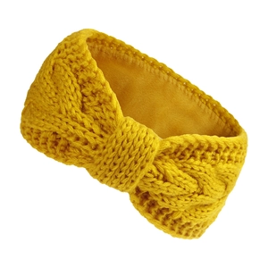 Detail of yellow knit headband with thick cable texture and warm fleece lining