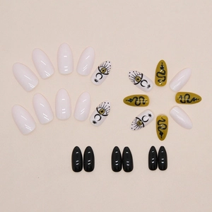 Snake pattern press-on nails set with minimalist eye and moon symbols in black, white, yellow