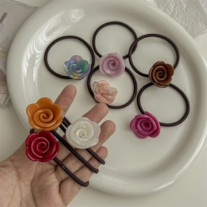 Set of eight elegant resin rose hair ties in various colors displayed in a ceramic tray