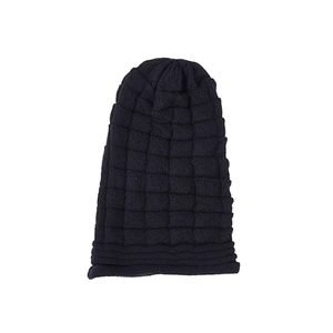 Close-up of black waffle knit texture on women's winter beanie hat for outdoor