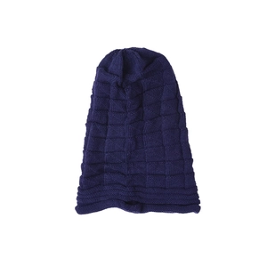 Detailed view of the navy blue chunky knit pattern and ribbed cuff on the warm beanie