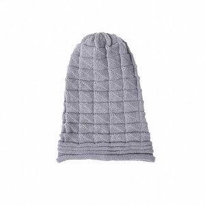 Close-up of light grey beanie showing textured checkerboard knit pattern and soft fabric