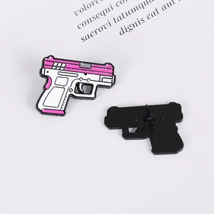 Detailed front and back view of a pink cartoon pistol enamel pin with butterfly clutch