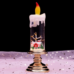 Macro detail of Christmas LED lantern showing miniature house, snow, and golden base