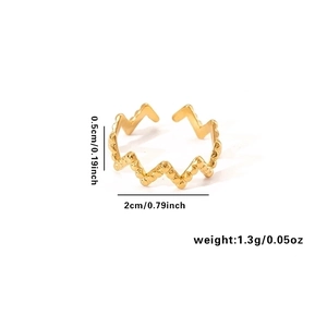 Detail view of golden wave-shaped steel ring with dimensions 0.5cm height and 1.3g weight