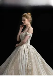 Close-up of luxury champagne wedding dress featuring intricate sequin and floral lace embroidery