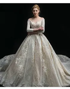 Detailed macro shot of luxury lace embroidery and sequins on this long sleeve bridal gown