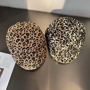 Classic leopard print ivy cap in light brown and grey styles on a dark surface