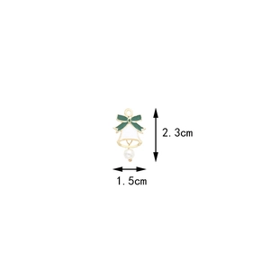 Detailed view of bell pendant with green bow and pearl, height 2.3cm and width 1.5cm