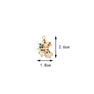 Christmas bell and holly leaf alloy charm detail with 2.6cm by 1.8cm size measurements