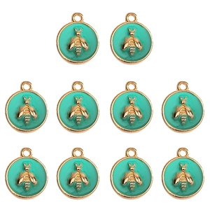 Detailed view of ten turquoise enamel round bee pendants with gold-plated alloy frames
