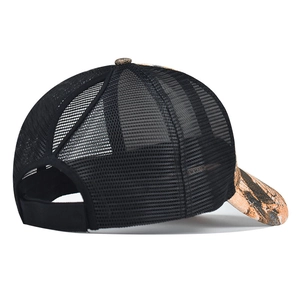Detail view of breathable black mesh trucker hat with camouflage textured visor
