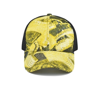 Detail of abstract tie-dye print on cotton visor with breathable black mesh backing