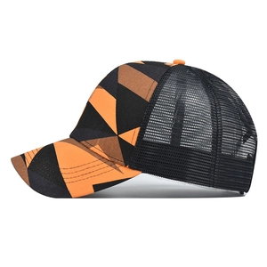 Side view of tie-dye ponytail mesh cap with orange and black geometric pattern