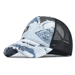 Close-up of blue denim brim with reinforced stitching and black mesh paneling on the cap