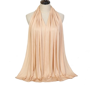 Detail showing the soft drape and breathable texture of the apricot modal scarf