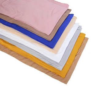 Stack of colorful mercerized cotton scarves showing soft texture and vibrant multi-color options