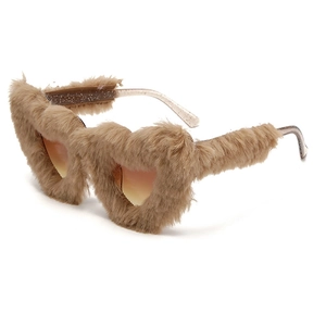 Close-up of heart-shaped sunglasses with light brown plush fur frames and tinted lenses